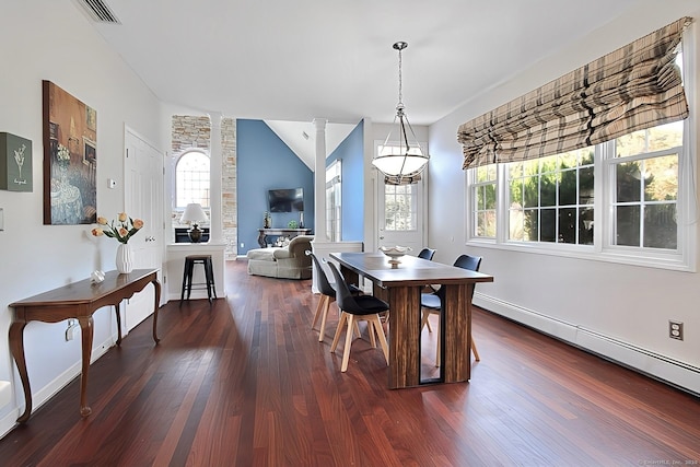 dining area featuring decorative columns, lofted ceiling, dark hardwood / wood-style floors, and a baseboard heating unit