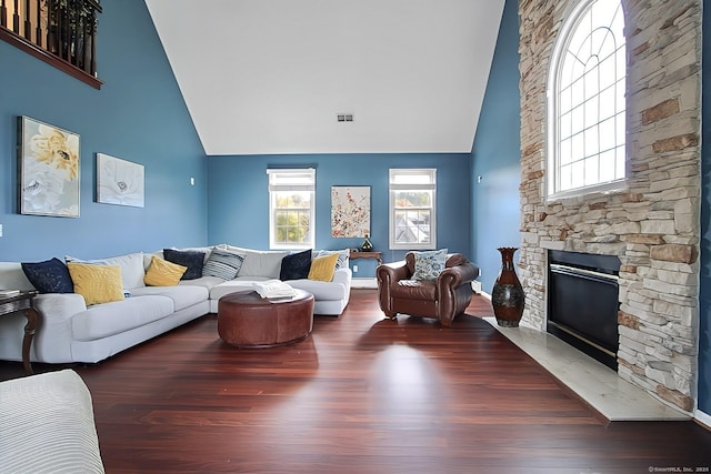 living room with vaulted ceiling, a fireplace, and dark hardwood / wood-style floors