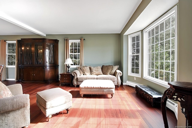 living room featuring beam ceiling, wood-type flooring, and a baseboard heating unit