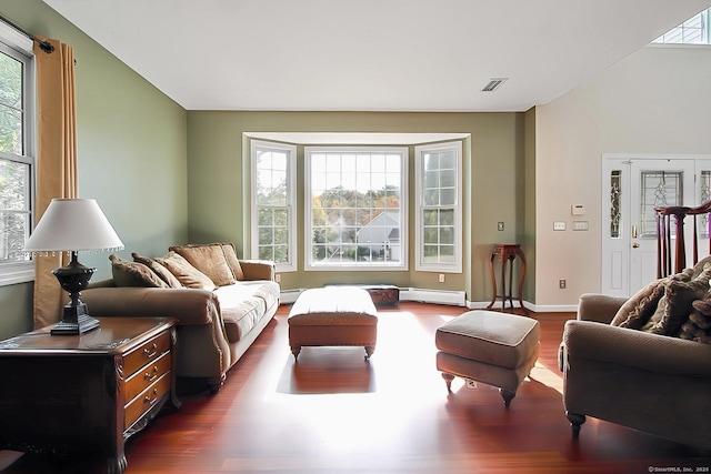 sitting room featuring dark hardwood / wood-style flooring and a baseboard heating unit