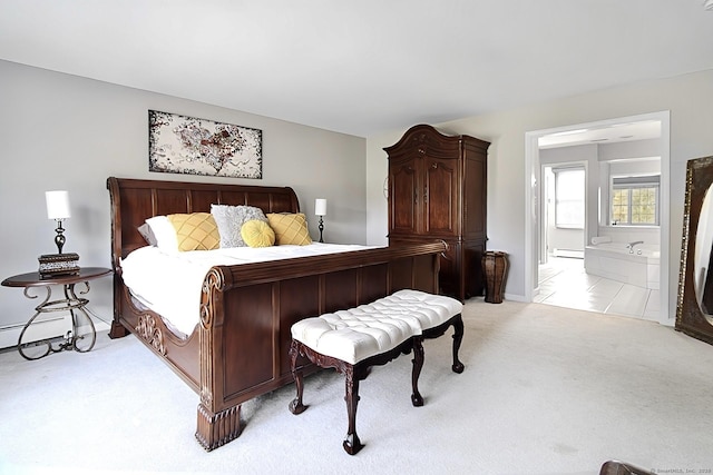 bedroom with light colored carpet and a baseboard heating unit