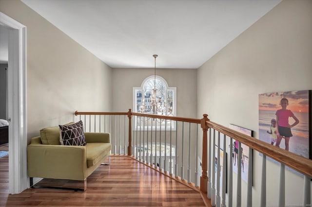 hall featuring hardwood / wood-style floors and an inviting chandelier