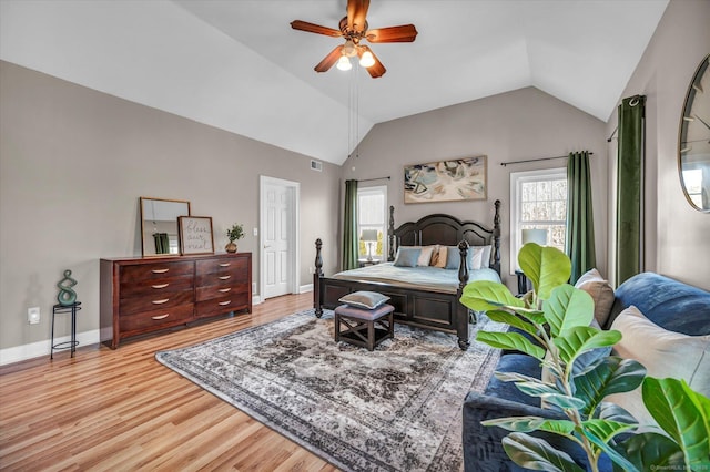 bedroom featuring light hardwood / wood-style flooring, ceiling fan, and lofted ceiling