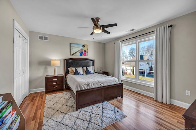 bedroom featuring light hardwood / wood-style flooring, a closet, and ceiling fan