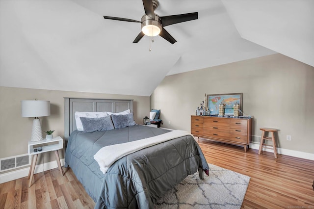 bedroom with ceiling fan, lofted ceiling, and light hardwood / wood-style flooring