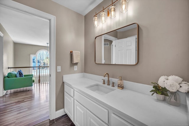 bathroom with vanity and hardwood / wood-style flooring