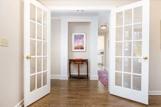 corridor featuring ornamental molding, dark hardwood / wood-style flooring, and french doors