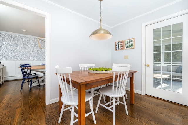 dining space featuring dark hardwood / wood-style flooring and crown molding