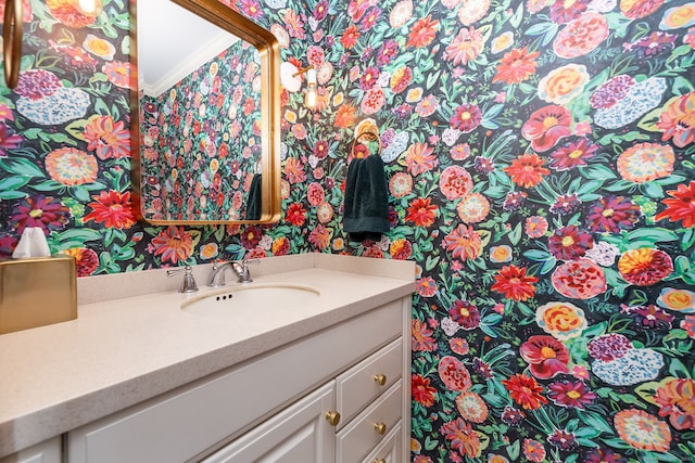 bathroom with vanity and ornamental molding