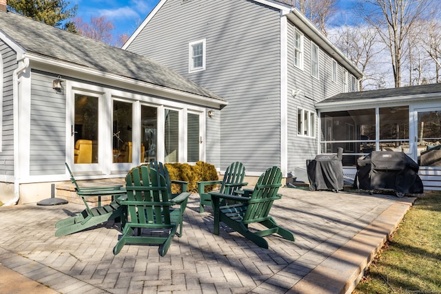 rear view of property featuring a patio area and a sunroom