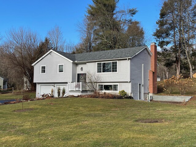 split foyer home with a front lawn and a garage