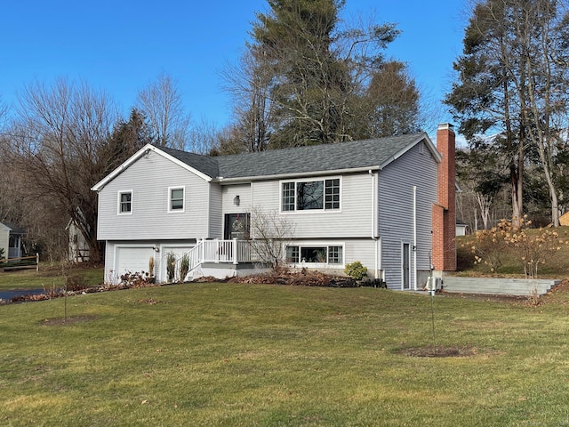 bi-level home featuring a garage and a front yard