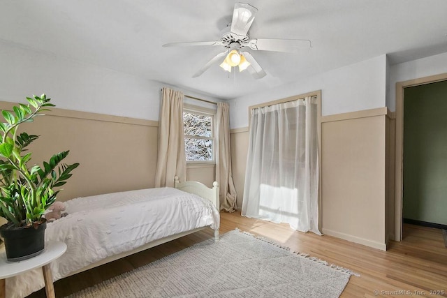 bedroom with ceiling fan and light wood-type flooring