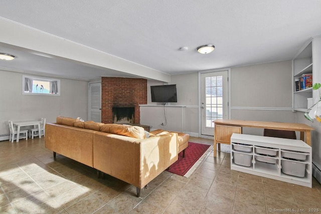 living room with a brick fireplace and a wealth of natural light