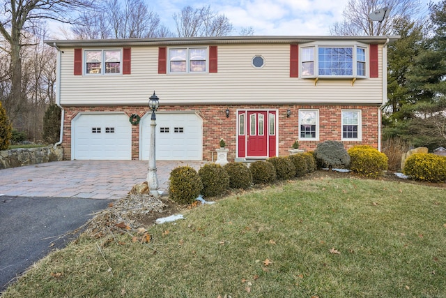 view of front of house with a front yard and a garage