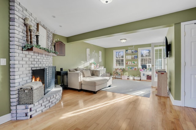 living room featuring a fireplace and light hardwood / wood-style flooring