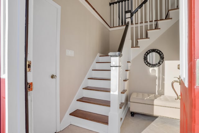 stairs featuring tile patterned flooring