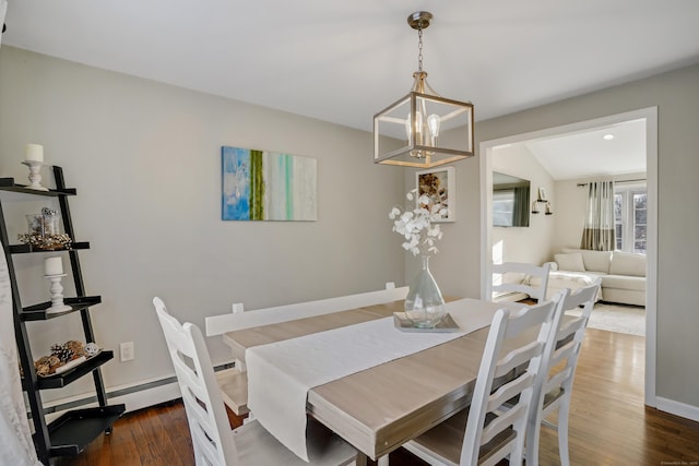 dining room with dark wood-type flooring, vaulted ceiling, and a notable chandelier