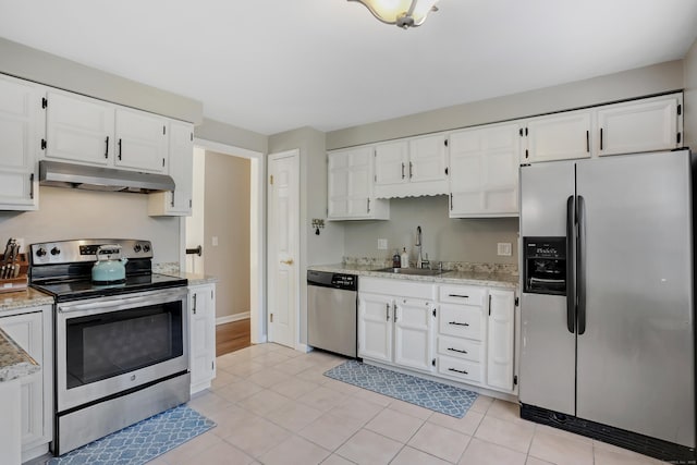 kitchen with light tile patterned flooring, appliances with stainless steel finishes, white cabinetry, and sink