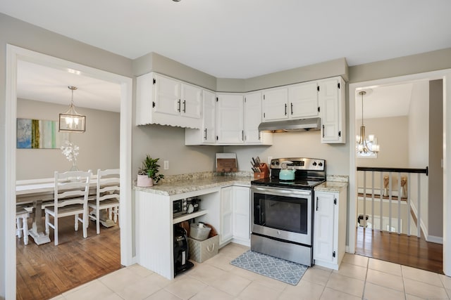 kitchen with stainless steel range with electric stovetop, light tile patterned flooring, white cabinets, and hanging light fixtures