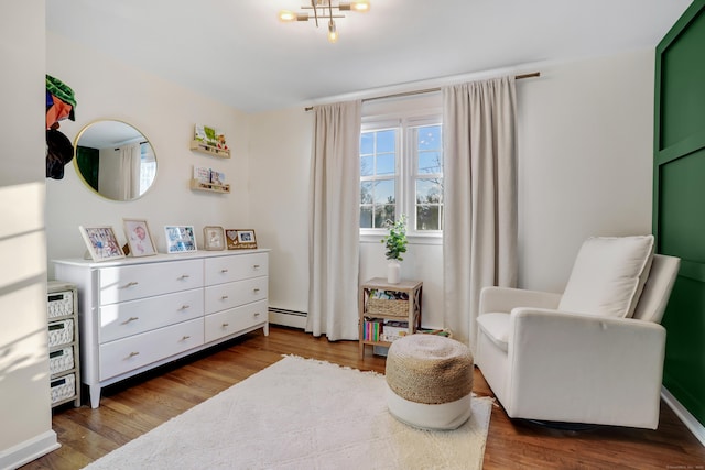 sitting room with wood-type flooring and a baseboard radiator