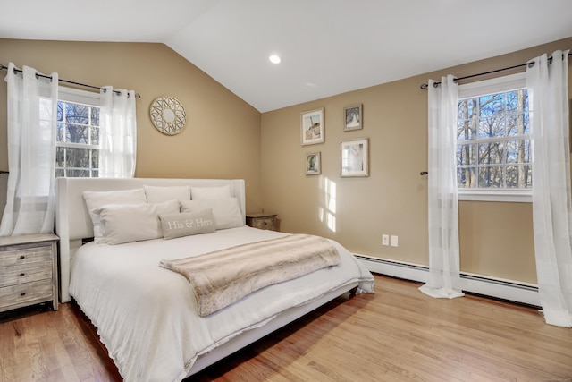 bedroom with hardwood / wood-style floors and vaulted ceiling