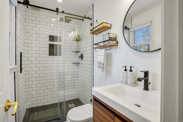 bathroom with vanity, toilet, and walk in shower