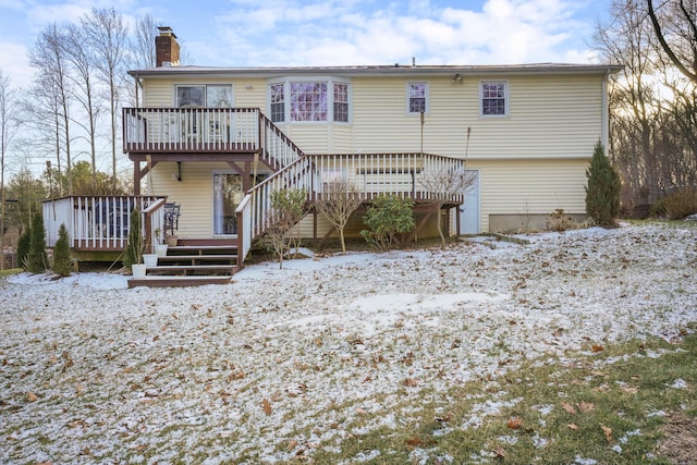 snow covered house featuring a wooden deck