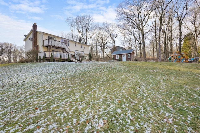 view of yard featuring a wooden deck and an outbuilding