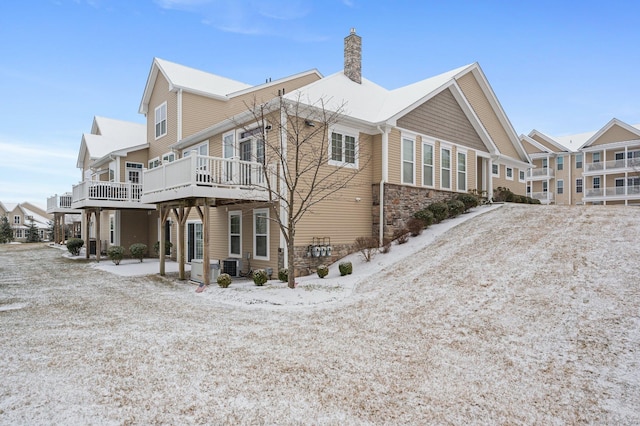 view of side of home with central air condition unit and a wooden deck