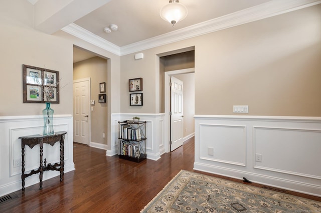 corridor featuring ornamental molding and dark wood-type flooring