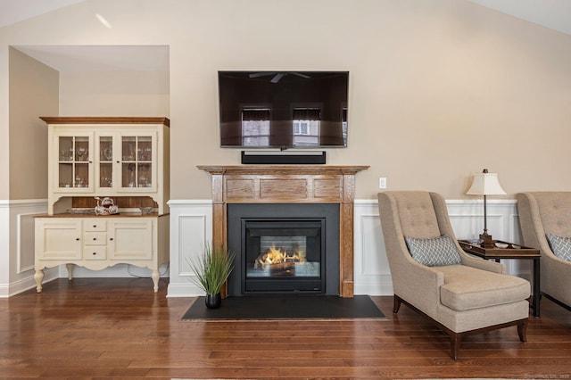 sitting room with dark wood-type flooring and lofted ceiling