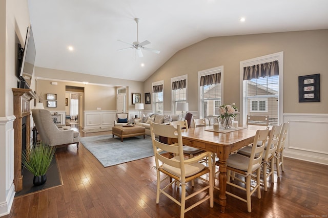 dining room with ceiling fan, dark hardwood / wood-style flooring, and vaulted ceiling