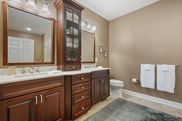 bathroom featuring tile patterned floors, vanity, and toilet