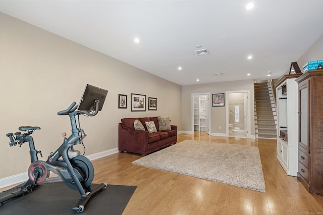 workout room featuring light wood-type flooring