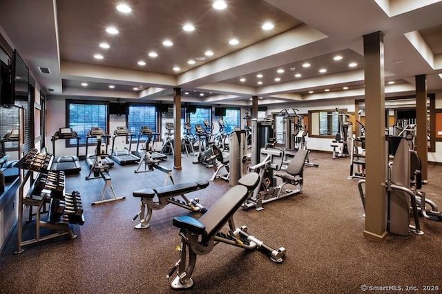 workout area featuring a tray ceiling