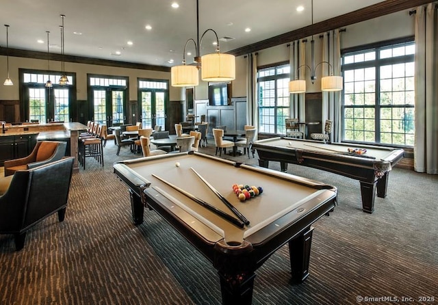 rec room with french doors, dark carpet, crown molding, and pool table