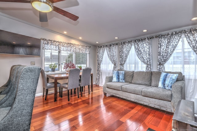 living room featuring ceiling fan, wood-type flooring, lofted ceiling, and ornamental molding