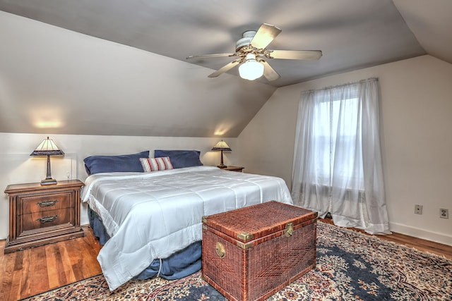 bedroom featuring wood-type flooring, vaulted ceiling, and ceiling fan