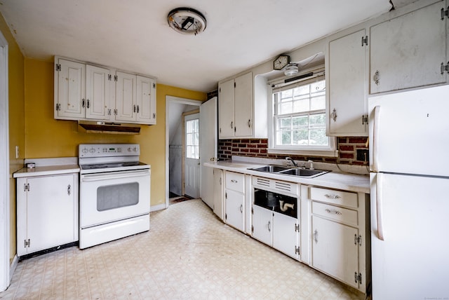 kitchen featuring white cabinetry, sink, and white appliances