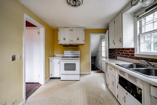 kitchen with white range with electric stovetop, a wealth of natural light, white cabinetry, and sink