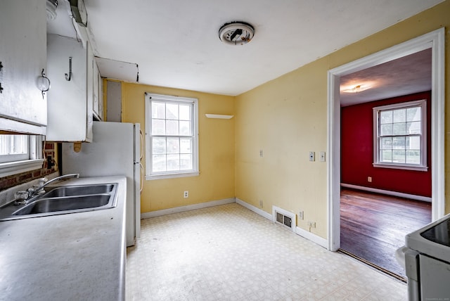 kitchen featuring white appliances and sink