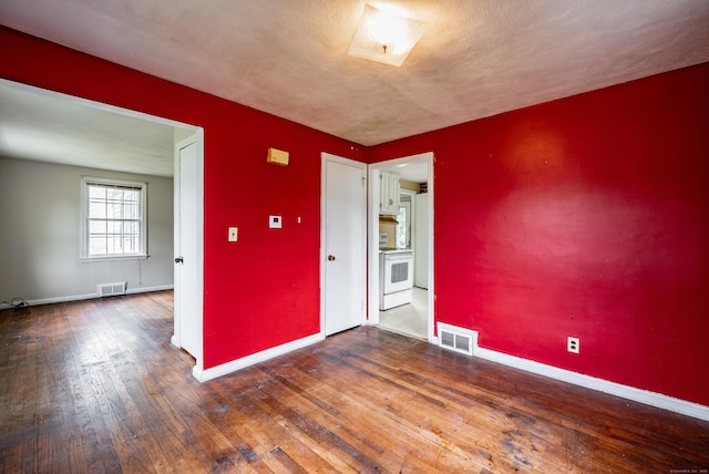 empty room featuring hardwood / wood-style flooring