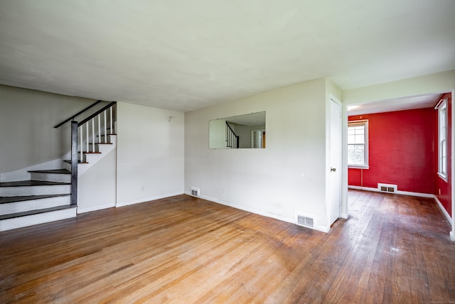 unfurnished living room featuring hardwood / wood-style flooring