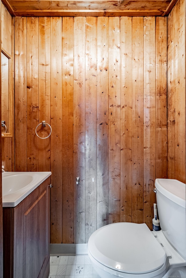 bathroom with vanity, wood walls, toilet, and wooden ceiling