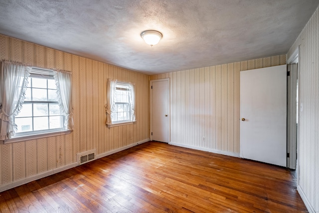 unfurnished room with wood-type flooring