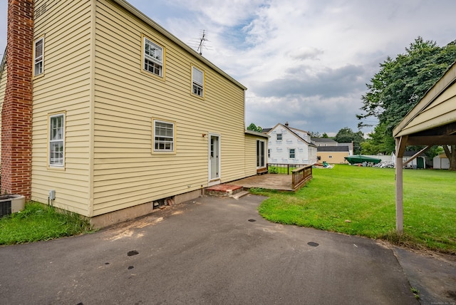 view of side of home featuring a yard and central air condition unit