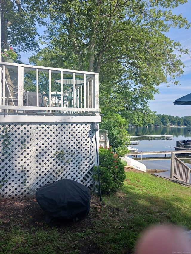 view of yard featuring a boat dock and a water view