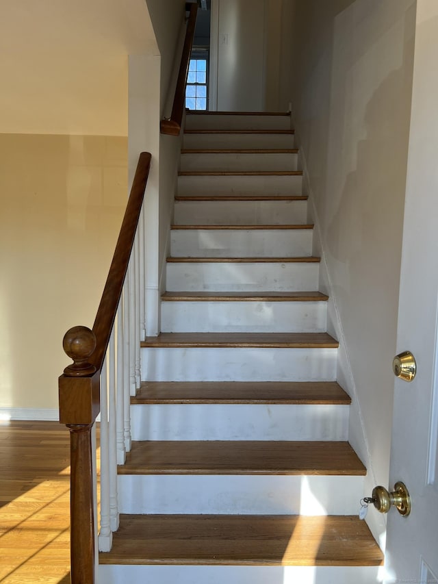 stairs with hardwood / wood-style floors