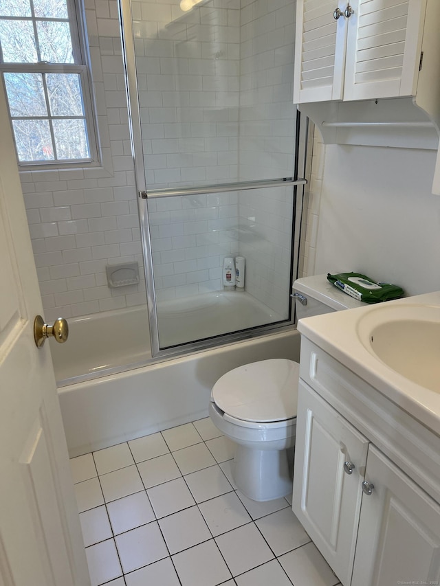 full bathroom with toilet, tile patterned flooring, vanity, and combined bath / shower with glass door